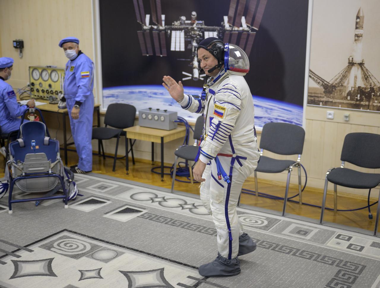 Roscosmos cosmonaut Alexey Ovchinin waves as he prepares to have his Russian Sokol suit pressure checked as he and fellow crew mates, NASA astronaut Don Pettit, and Roscosmos cosmonaut Ivan Vagner, prepare for their Soyuz launch to the International Space Station Wednesday, Sept. 11, 2024 in Baikonur, Kazakhstan. The launch will send Pettit, Ovchinin, and Vagner on a mission to the International Space Station. Photo Credit: (NASA/Bill Ingalls)