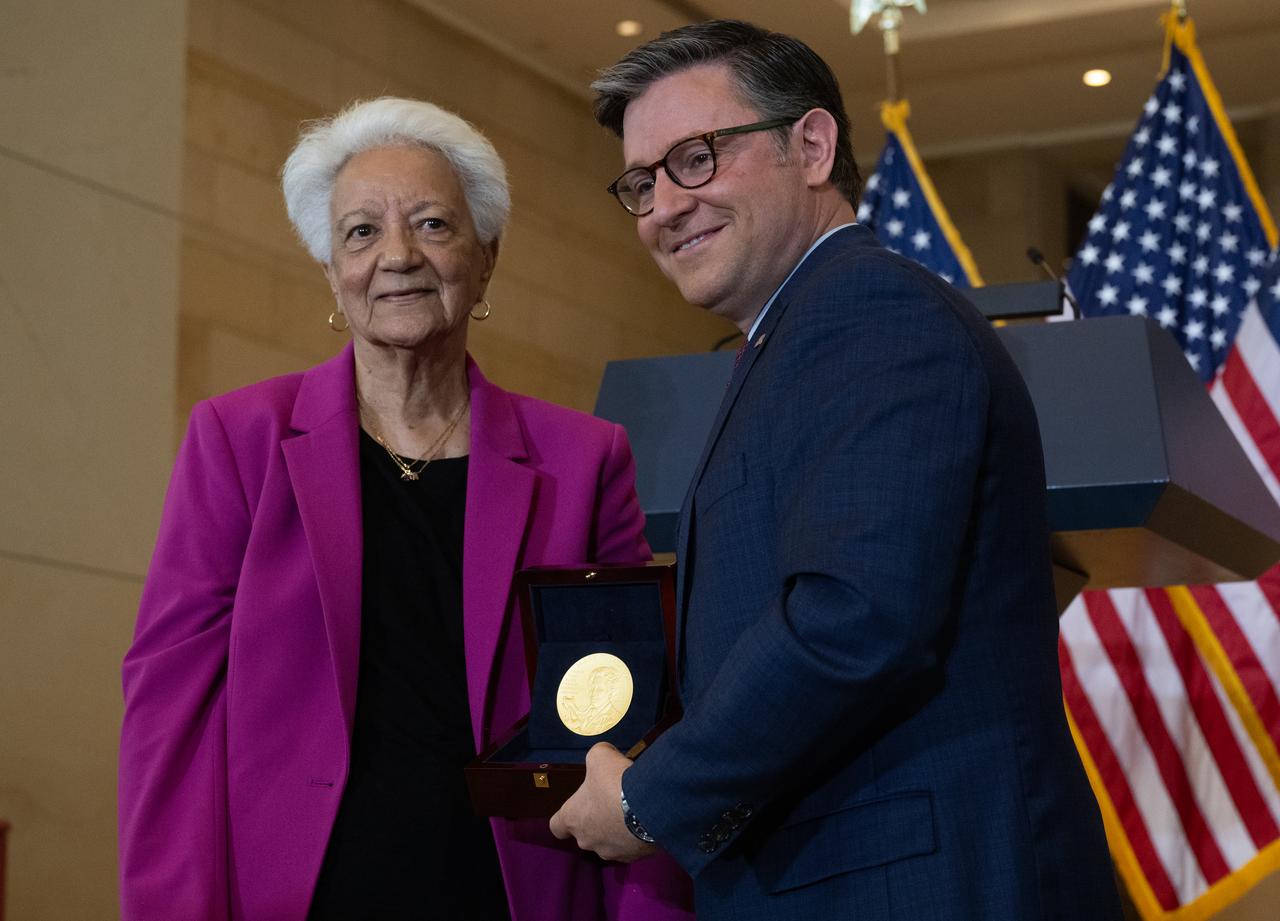 Wanda Jackson, granddaughter of Mary W. Jackson, accepts the Congressional Gold Medal on behalf of Mary W. Jackson from Speaker of the House Mike Johnson (R-LA) during a ceremony recognizing NASA’s Hidden Figures, Wednesday, Sept. 18, 2024, in Emancipation Hall at the U.S. Capitol in Washington. Congressional Gold Medals were awarded to Katherine Johnson, Dr. Christine Darden, Dorothy Vaughan, and Mary W. Jackson in recognition of their service to the United States as well as a Congressional Gold Medal in recognition of all the women who served as computers, mathematicians, and engineers at the National Advisory Committee for Aeronautics and NASA between the 1930s and 1970s.  Photo Credit: (NASA/Joel Kowsky)