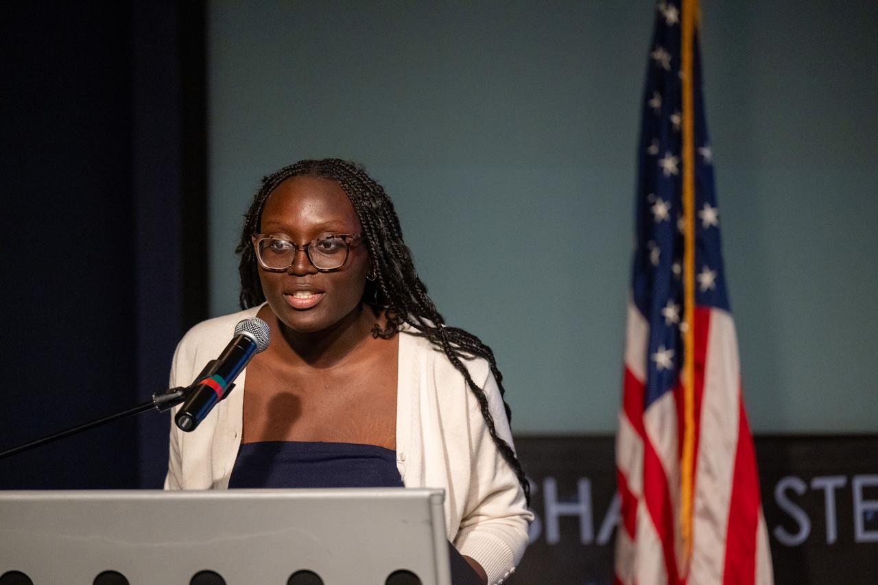 Brainy Akpala recites her poem “Sitting Upon Flames” during a 5th Annual Hidden Figures Street Naming Anniversary event Thursday, Sept. 19, 2024, at the Mary W. Jackson NASA Headquarters building in Washington. Photo Credit: (NASA/Keegan Barber)
