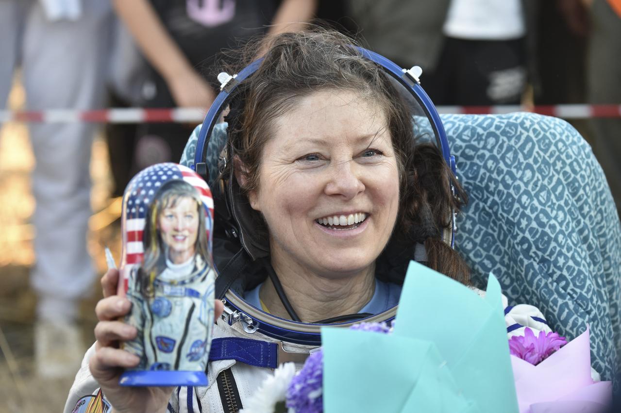 NASA astronaut Tracy C. Dyson is seen smiling and holding a gifted matryoshka doll outside the Soyuz MS-25 spacecraft after she landed with Roscosmos cosmonauts Oleg Kononenko and Nikolai Chub, in a remote area near the town of Zhezkazgan, Kazakhstan on Monday, Sept. 23, 2024. Dyson is returning to Earth after logging 184 days in space as a member of Expeditions 70-71 aboard the International Space Station and Chub and Kononenko return after having spent the last 374 days in space. Photo Credit NASA/GCTC/Pavel Shvets