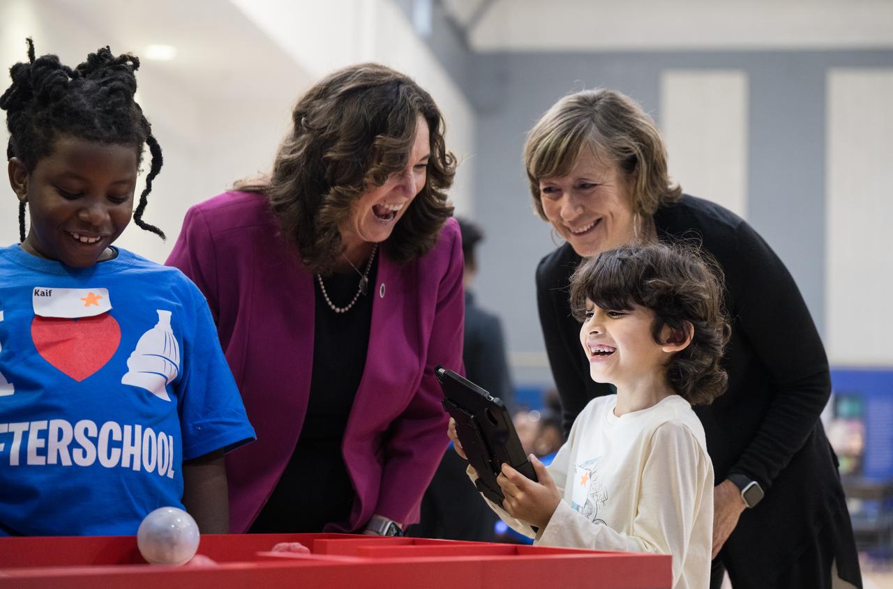 NASA Deputy Associate Administrator for NASA’s Office of STEM Engagement, Kris Brown, right, and U.S. Department of Education Deputy Secretary Cindy Marten, left, watch as a student operates a robot during a STEM event to kickoff the 21st Century Community Learning Centers NASA and U.S. Department of Education partnership, Monday, Sept. 23, 2024 at Wheatley Education Campus (EC) in Washington. Students engaged in NASA hands-on activities and an engineering design challenge. Photo Credit: (NASA/Aubrey Gemignani)