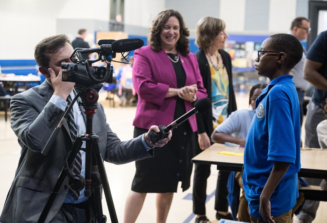 A student at Wheatley Education Campus is interviewed by media during a kickoff event for the 21st Century Community Learning Centers NASA and Department of Education partnership, Monday, Sept. 23, 2024 at Wheatley Education Campus in Washington. Photo Credit: (NASA/Aubrey Gemignani)