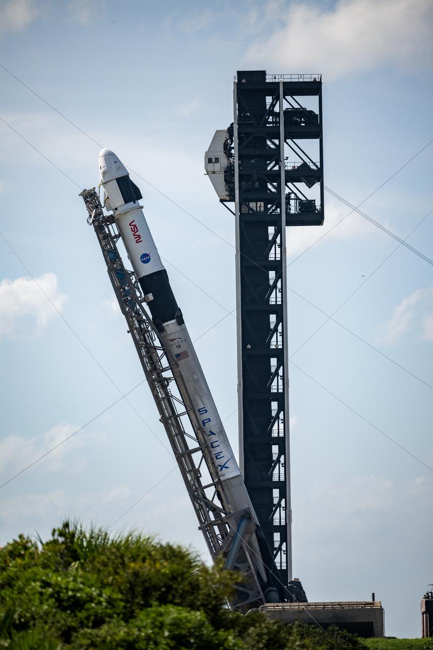 A SpaceX Falcon 9 rocket with the company's Dragon spacecraft on top is seen as it is raised into a vertical position on the launch pad at Space Launch Complex 40 as preparations continue for the Crew-9 mission, Friday, Sept. 27, 2024, at Cape Canaveral Space Force Station in Florida. NASA’s SpaceX Crew-9 mission is the ninth crew rotation mission of the SpaceX Dragon spacecraft and Falcon 9 rocket to the International Space Station as part of the agency’s Commercial Crew Program. NASA astronaut Nick Hague and Roscosmos cosmonaut Aleksandr Gorbunov are scheduled to launch on 1:17 p.m. EDT on Saturday, Sept. 28, from Space Launch Complex 40 at the Cape Canaveral Space Force Station. Photo Credit: (NASA/Keegan Barber)