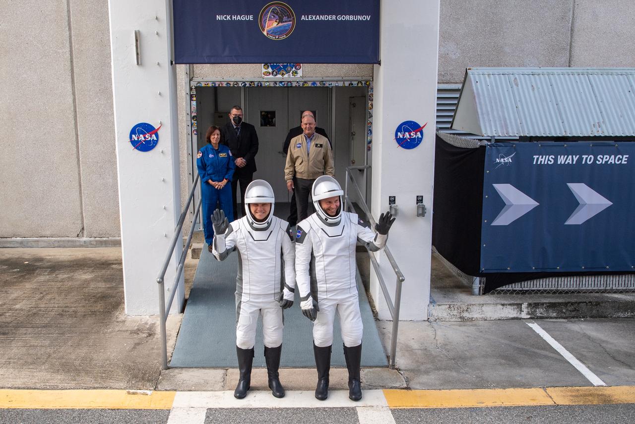 Roscosmos cosmonaut Aleksandr Gorbunov, left, and NASA astronaut Nick Hague, right, wearing SpaceX spacesuits, are seen as they prepare to depart the Neil A. Armstrong Operations and Checkout Building for Space Launch Complex 40 on Cape Canaveral Space Force Station to board the SpaceX Dragon spacecraft for the Crew-9 mission launch, Saturday, Sept. 28, 2024, at NASA’s Kennedy Space Center in Florida. NASA’s SpaceX Crew-9 mission is the ninth crew rotation mission of the SpaceX Dragon spacecraft and Falcon 9 rocket to the International Space Station as part of the agency’s Commercial Crew Program. Hague and Gorbunov are scheduled to launch at 1:17 p.m. EDT, from Space Launch Complex 40 at the Cape Canaveral Space Force Station. Photo Credit: (NASA/Keegan Barber)