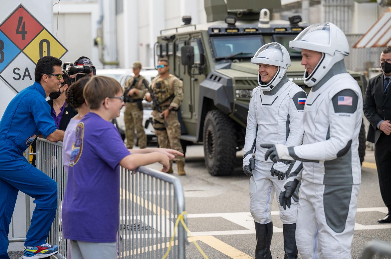 Roscosmos cosmonaut Aleksandr Gorbunov and NASA astronaut Nick Hague speak with family and friends as they prepare to depart the Neil A. Armstrong Operations and Checkout Building for Space Launch Complex 40 on Cape Canaveral Space Force Station to board the SpaceX Dragon spacecraft for the Crew-9 mission launch, Saturday, Sept. 28, 2024, at NASA’s Kennedy Space Center in Florida. NASA’s SpaceX Crew-9 mission is the ninth crew rotation mission of the SpaceX Dragon spacecraft and Falcon 9 rocket to the International Space Station as part of the agency’s Commercial Crew Program. Hague and Gorbunov are scheduled to launch at 1:17 p.m. EDT, from Space Launch Complex 40 at the Cape Canaveral Space Force Station. Photo Credit: (NASA/Keegan Barber)