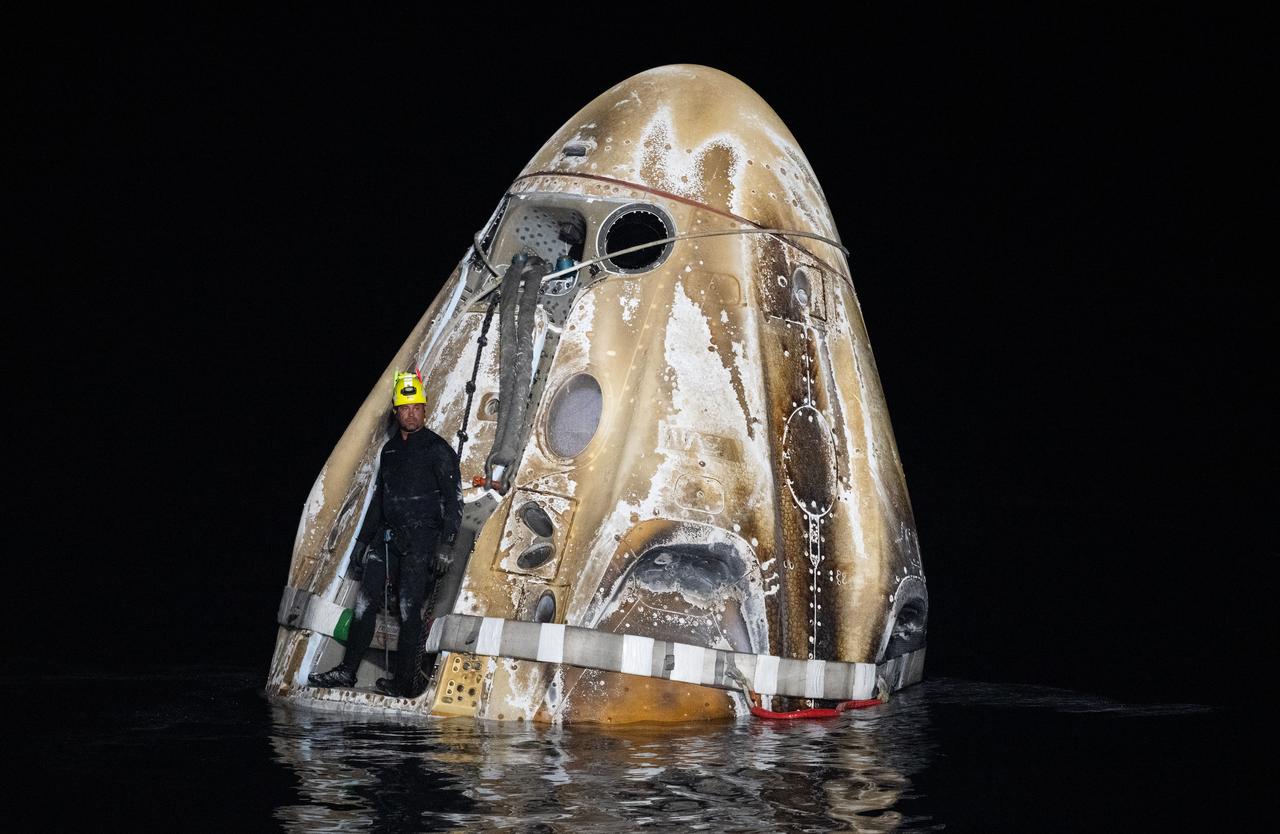Support teams work around the SpaceX Dragon Endeavour spacecraft shortly after it landed with NASA astronauts Matthew Dominick, Michael Barratt, and Jeanette Epps, and Roscosmos cosmonaut Alexander Grebenkin aboard in the Gulf of Mexico off the coast of Pensacola, Florida, Friday, Oct. 25,2024. Dominick, Barratt, Epps, Grebenkin are returning after seven-months in space as part of Expedition 70 aboard the International Space Station. Photo Credit: (NASA/Joel Kowsky)