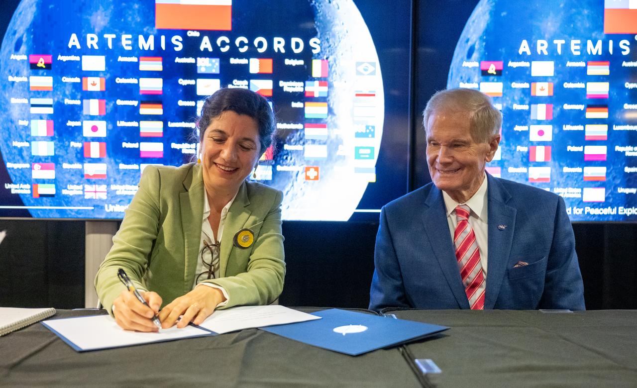NASA Administrator Bill Nelson, right, looks on as Chilean Minister of Science, Technology, Knowledge, and Innovation Aisén Etcheverry Escudero, left, signs the Artemis Accords Friday, Oct. 25, 2024, at the Mary W. Jackson NASA Headquarters building in Washington. The Republic of Chile is the 47th country to sign the Artemis Accords, which establish a practical set of principles to guide space exploration cooperation among nations participating in NASA’s Artemis program. Photo Credit: (NASA/Keegan Barber)