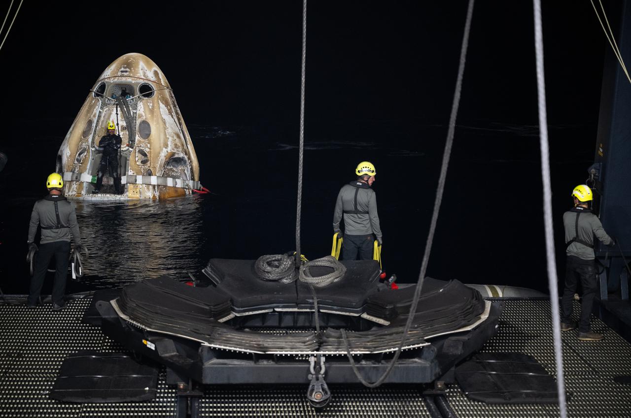 Support teams prepare to raise the SpaceX Dragon Endeavour spacecraft aboard the recovery ship MEGAN shortly after it landed with NASA astronauts Matthew Dominick, Michael Barratt, and Jeanette Epps, and Roscosmos cosmonaut Alexander Grebenkin aboard in theGulf of Mexico off the coast of Pensacola, Florida, Friday, Oct. 25, 2024. Dominick, Barratt, Epps, Grebenkin are returning after seven-months in space as part of Expedition 71 aboard the International Space Station. Photo Credit: (NASA/Joel Kowsky)