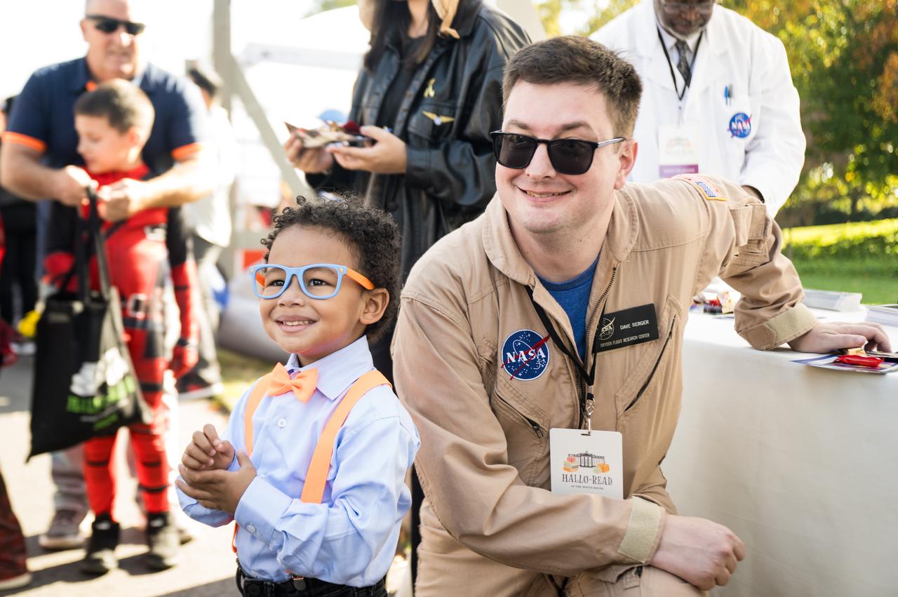 A NASA staff member poses with a visitor for a photo at a White House Halloween themed event titled, “Hallo-READ!” on Wednesday, Oct. 30, 2024 on the south lawn of the White House in Washington. Photo Credit: (NASA/Aubrey Gemignani)