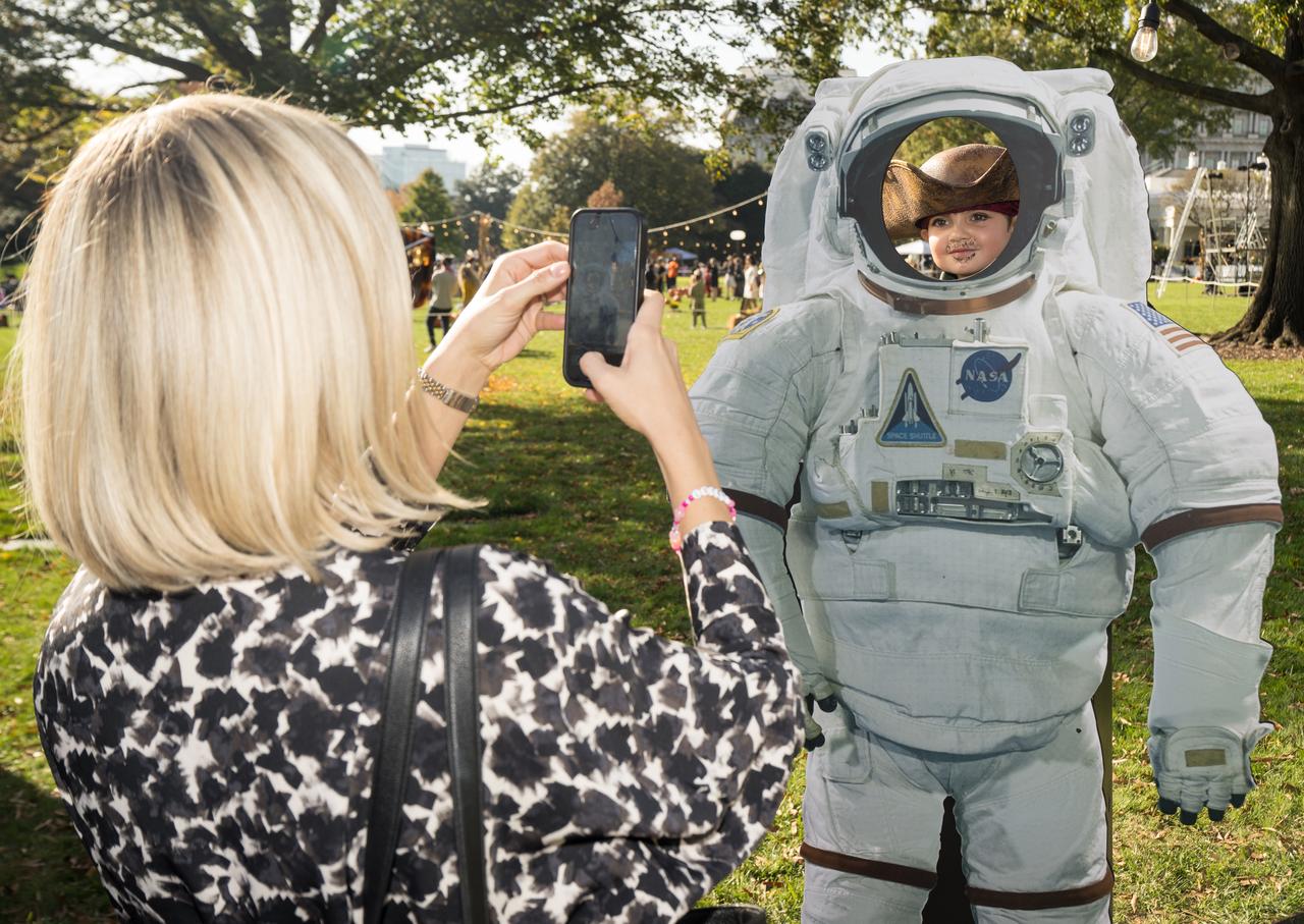 A visitor poses for a photo at a White House Halloween themed event titled, “Hallo-READ!” on Wednesday, Oct. 30, 2024 on the south lawn of the White House in Washington. Photo Credit: (NASA/Aubrey Gemignani)