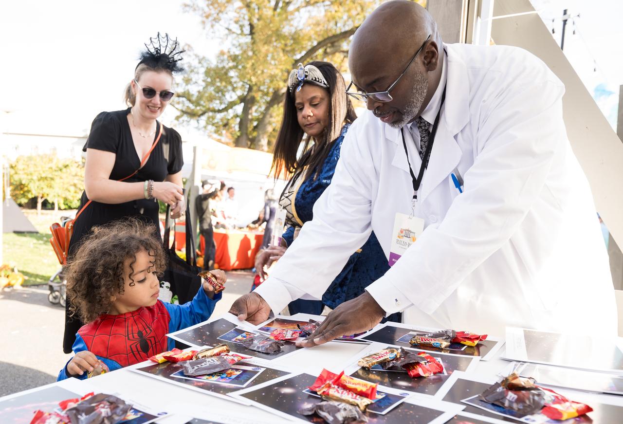 NASA staff hand out candy at a White House Halloween themed event titled, “Hallo-READ!” on Wednesday, Oct. 30, 2024 on the south lawn of the White House in Washington. Photo Credit: (NASA/Aubrey Gemignani)