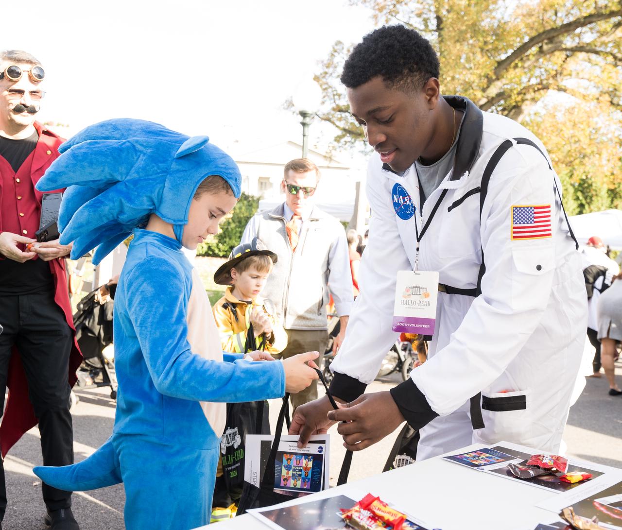 NASA staff hand out candy at a White House Halloween themed event titled, “Hallo-READ!” on Wednesday, Oct. 30, 2024 on the south lawn of the White House in Washington. Photo Credit: (NASA/Aubrey Gemignani)
