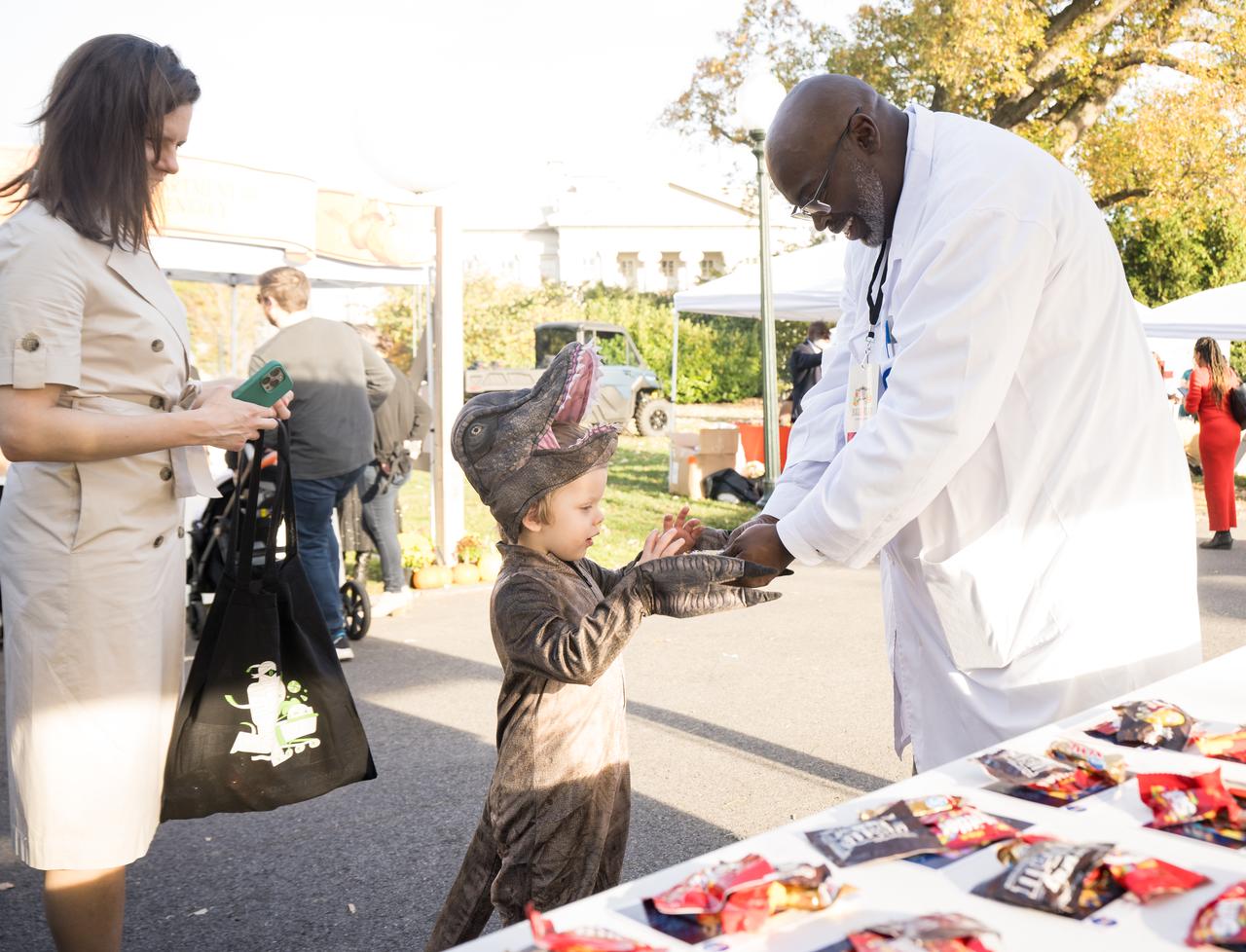 NASA staff hand out candy at a White House Halloween themed event titled, “Hallo-READ!” on Wednesday, Oct. 30, 2024 on the south lawn of the White House in Washington. Photo Credit: (NASA/Aubrey Gemignani)