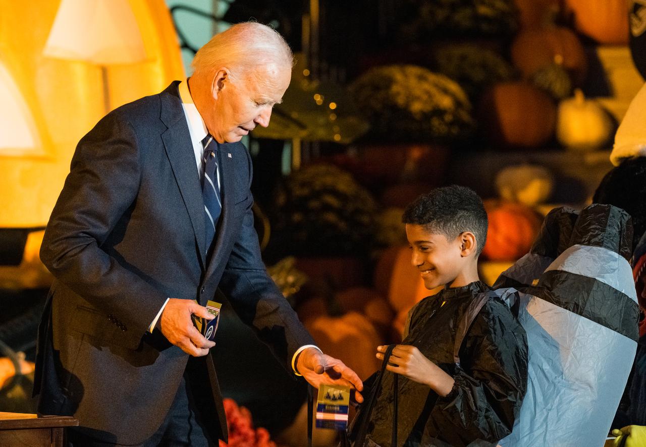 President Joe Biden hands out candy to a visitor dressed as a rocket at a White House Halloween themed event titled, “Hallo-READ!” on Wednesday, Oct. 30, 2024 on the south lawn of the White House in Washington. Photo Credit: (NASA/Aubrey Gemignani)