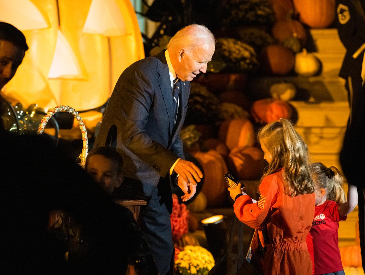 U.S. President Joe Biden hands out candy at a White House Halloween themed event titled, “Hallo-READ!” on Wednesday, Oct. 30, 2024 on the south lawn of the White House in Washington. Photo Credit: (NASA/Aubrey Gemignani)