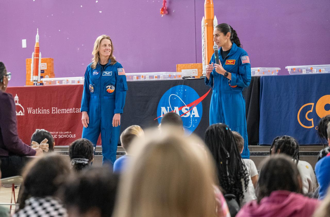 NASA astronauts Loral O’Hara and Jasmin Moghbeli, seen in blue flight suits, answer questions from students during an engagement event at Catherine Watkins Elementary School Monday, Dec. 2, 2024 in Washington. O’Hara and Moghbeli spent six months in space as part of Expedition 70 aboard the International Space Station. Photo Credit: (NASA/Keegan Barber)