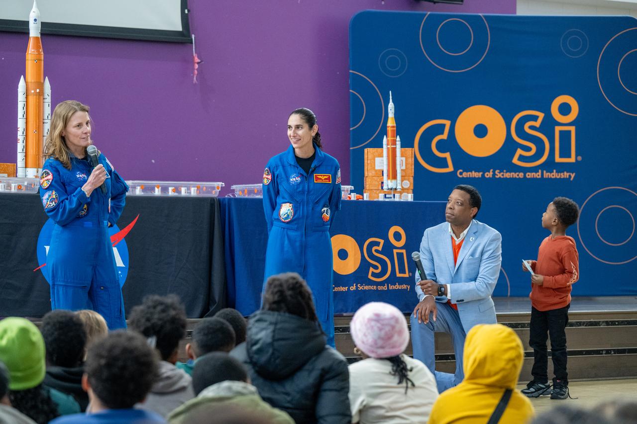 NASA astronauts Loral O’Hara and Jasmin Moghbeli, seen in blue flight suits, answer questions from students during an engagement event at Catherine Watkins Elementary School Monday, Dec. 2, 2024 in Washington. O’Hara and Moghbeli spent six months in space as part of Expedition 70 aboard the International Space Station. Photo Credit: (NASA/Keegan Barber)