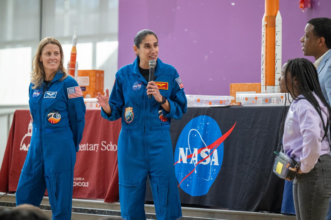 NASA astronauts Loral O’Hara and Jasmin Moghbeli, seen in blue flight suits, answer questions from students during an engagement event at Catherine Watkins Elementary School Monday, Dec. 2, 2024 in Washington. O’Hara and Moghbeli spent six months in space as part of Expedition 70 aboard the International Space Station. Photo Credit: (NASA/Keegan Barber)