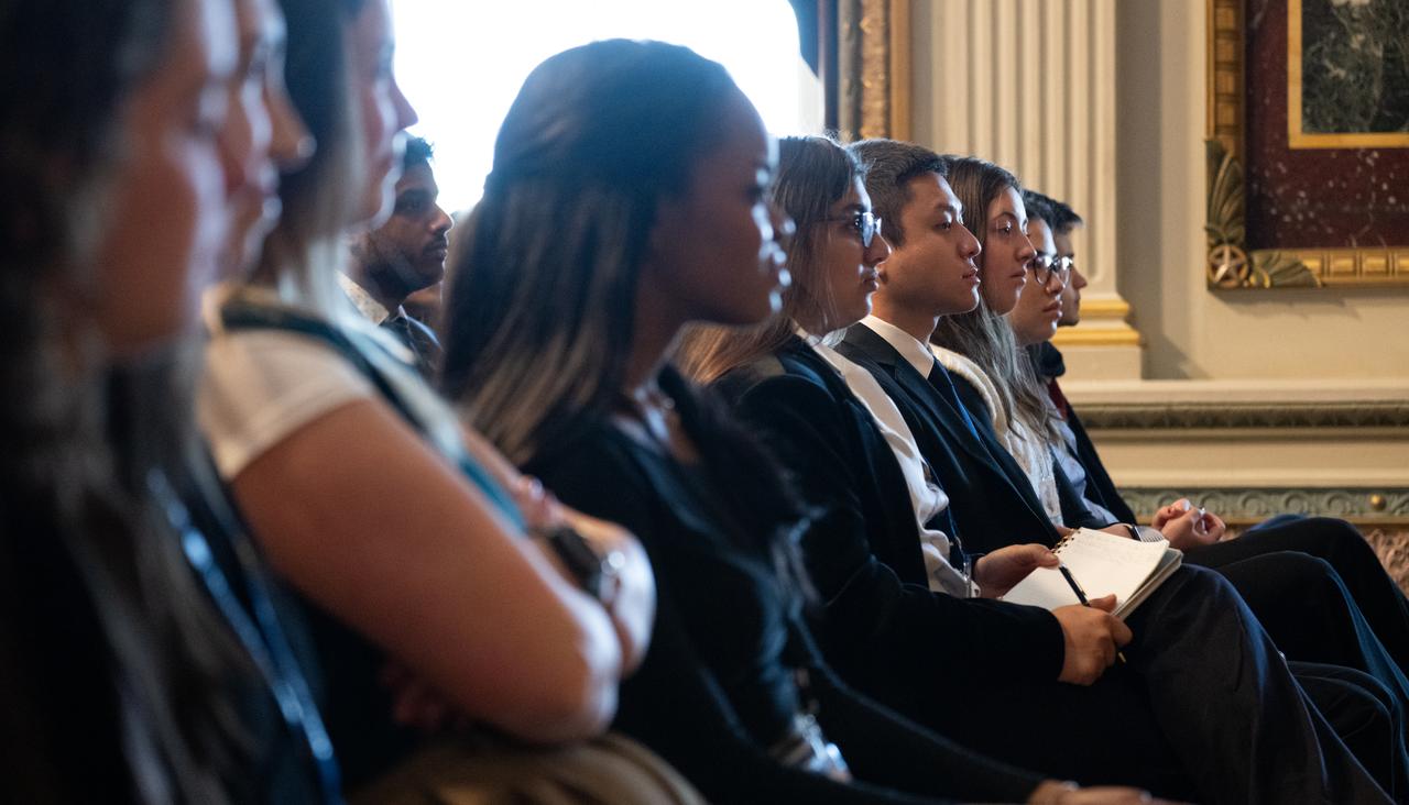 White House staff and interns listen to NASA astronauts Jasmin Moghbeli and Loral O’Hara during a fireside chat, Wednesday, Dec. 4, 2024 at the Eisenhower Executive Office Building in Washington. O’Hara and Moghbeli spent six months in space as part of Expedition 70 aboard the International Space Station.  Photo Credit: (NASA/Joel Kowsky)
