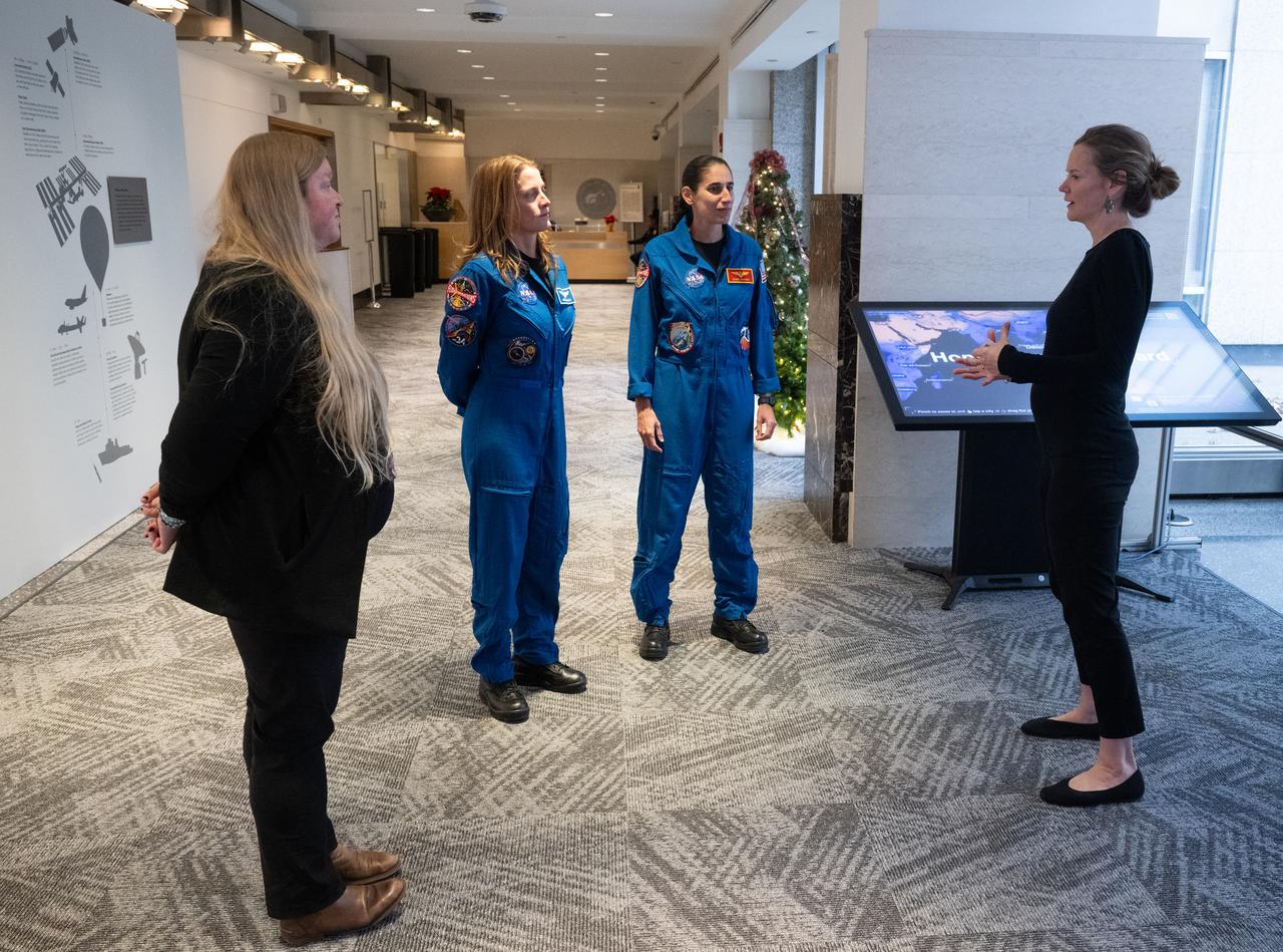 Eleanor Stokes, program manager for NASA’s Earth Information Center, right, and Nicole Ramberg-Pihl, project manager for NASA’s Earth Information Center, left, speak with NASA astronauts Loral O’Hara, second from left, and Jasmin Moghbeli, second from right, during a tour of the Earth Information Center, Wednesday, Dec. 4, 2024, at the Mary W. Jackson NASA Headquarters Building in Washington. O’Hara and Moghbeli spent six months in space as part of Expedition 70 aboard the International Space Station.  Photo Credit: (NASA/Joel Kowsky)