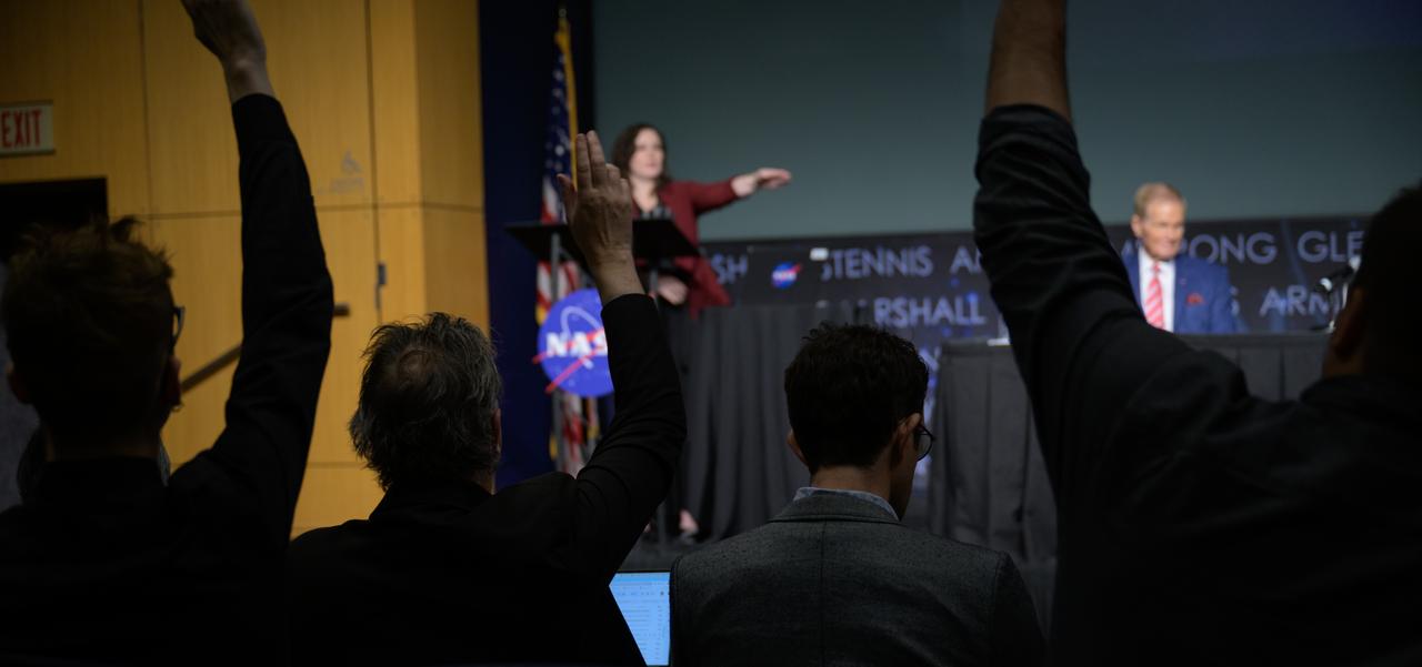 Reporters raise their hands to ask questions as Senior Advisor for NASA's Office of Communications Meira Bernstein moderates an update on NASA's Artemis campaign, Thursday, Dec. 5, 2024, at the NASA Headquarters Mary W. Jackson Building in Washington. Photo Credit: (NASA/Bill Ingalls)