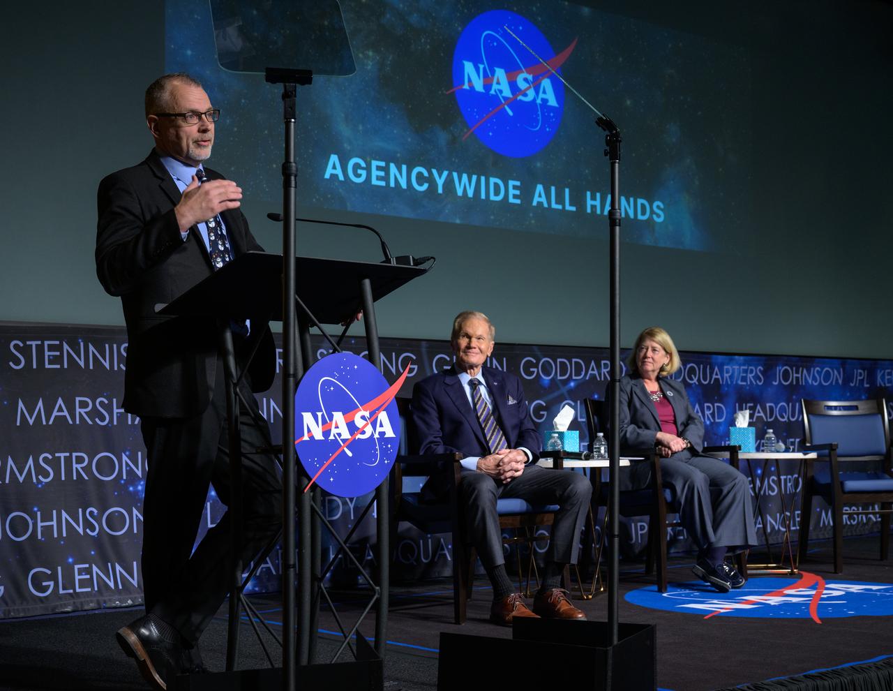 NASA Associate Administrator Jim Free, gives remarks during a NASA agencywide all hands, as NASA Administrator Bill Nelson, and, NASA Deputy Administrator Pam Melroy, right, look on, Friday, Dec. 6, 2024, at the NASA Headquarters Mary W. Jackson Building in Washington. Photo Credit: (NASA/Bill Ingalls)