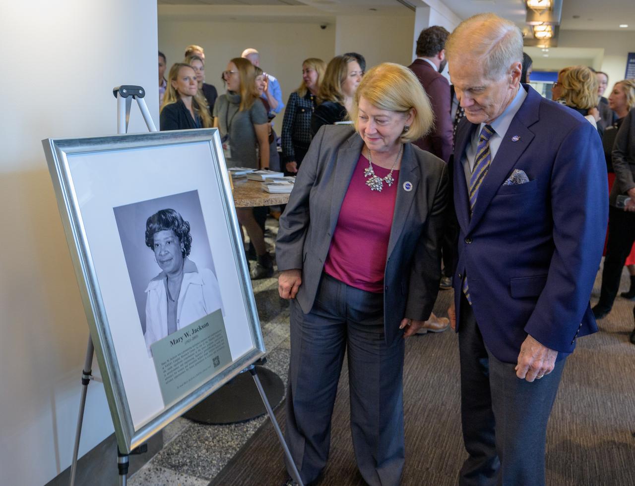 NASA Deputy Administrator Pam Melroy, and, NASA Administrator Bill Nelson, right, look at a portrait of Mary W. Jackson after it was unveiled, Friday, Dec. 6, 2024, at the NASA Headquarters Mary W. Jackson Building in Washington. Mary W. Jackson was a pioneering aerospace engineer and mathematician at NASA’s Langley Research Center. As one of the “Hidden Figures,” she made significant contributions to the space program, particularly in aerodynamics and engineering. Jackson’s groundbreaking work and advocacy for women and minorities helped shape NASA’s success and advance opportunities for future generations in science and technology. Photo Credit: (NASA/Bill Ingalls)