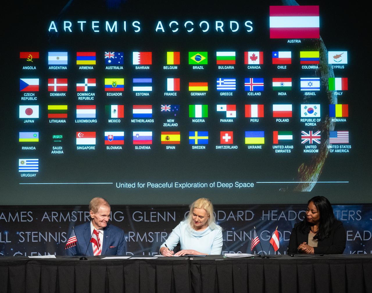NASA Administrator Bill Nelson, left, and U.S. Department of State Acting Assistant Secretary in the Bureau of Oceans and International Environmental and Scientific Affairs Jennifer R. Littlejohn, right, look on as Ambassador of the Republic of Austria to the United States of America Petra Schneebauer, signs the Artemis Accords, Wednesday, Dec. 11, 2024, at the Mary W. Jackson NASA Headquarters building in Washington. The Republic of Austria is the 50th country to sign the Artemis Accords, which establish a practical set of principles to guide space exploration cooperation among nations participating in NASA’s Artemis program. Photo Credit: (NASA/Joel Kowsky)