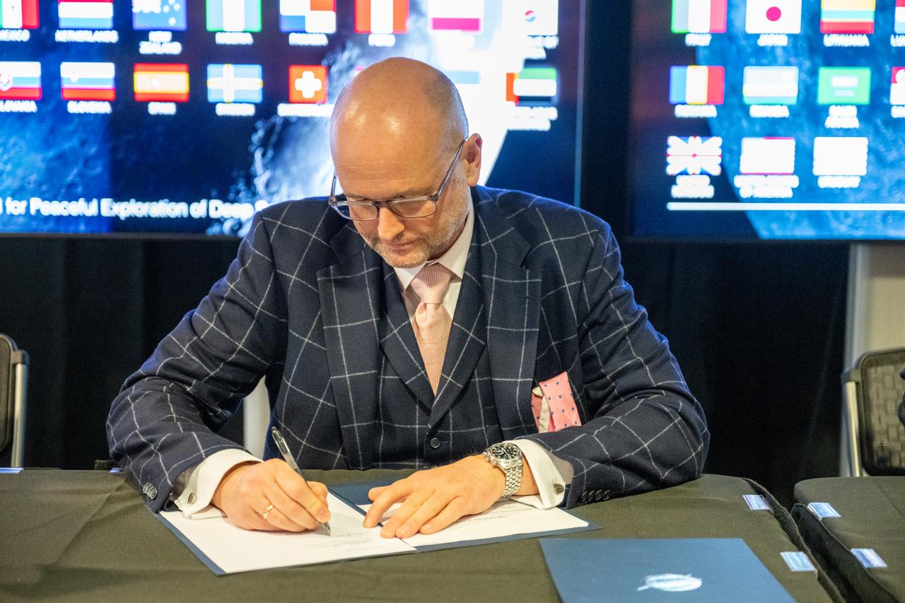Director of the Office for Communications of the Principality of Liechtenstein Dr. Rainer Schnepfleitner signs the Artemis Accords Friday, Dec. 20, 2024, at the Mary W. Jackson NASA Headquarters building in Washington. The Principality of Liechtenstein is the 52nd country to sign the Artemis Accords, which establish a practical set of principles to guide space exploration cooperation among nations participating in NASA’s Artemis program.Photo Credit: (NASA/Keegan Barber)