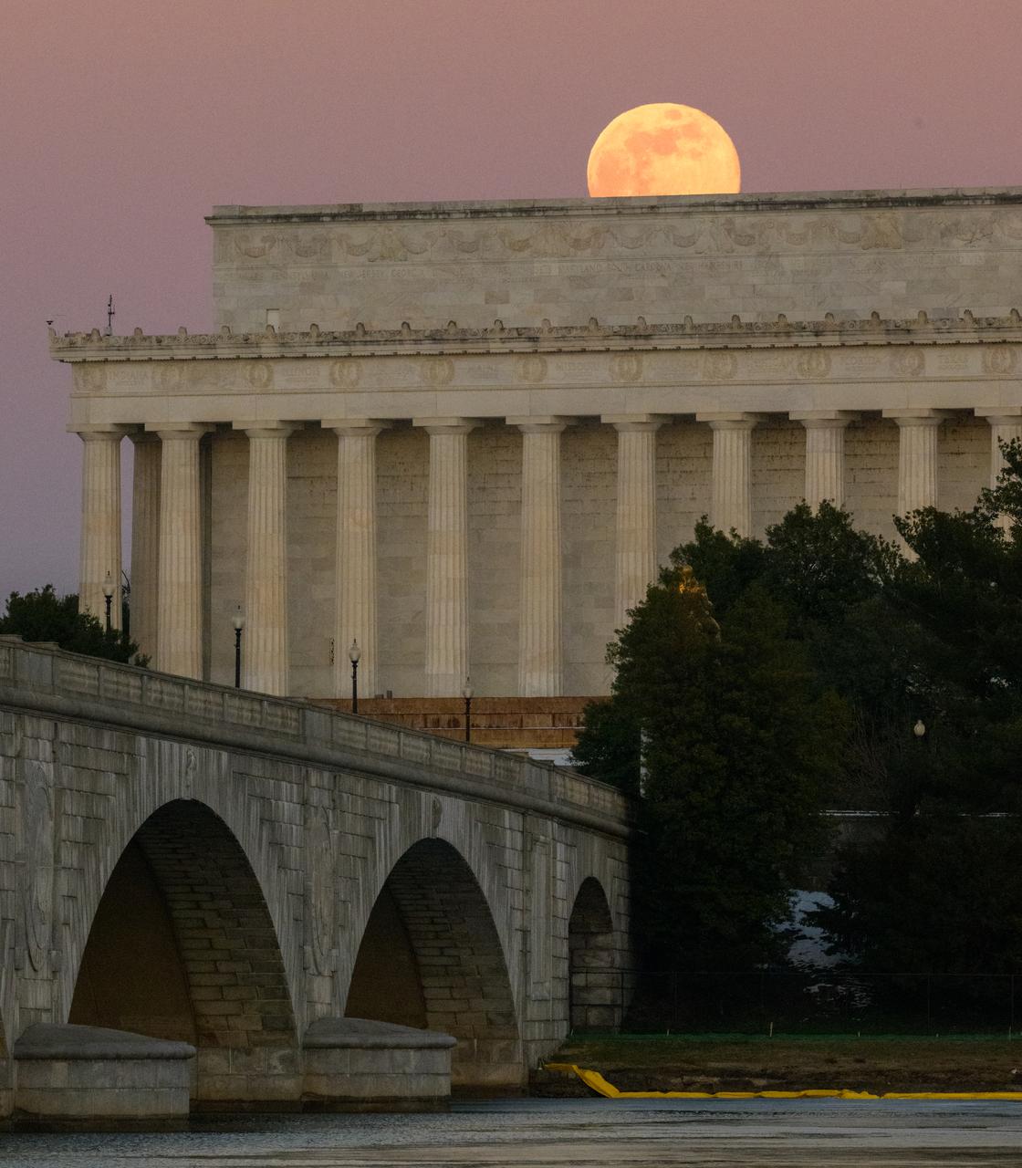 The full Moon, also known in January as the Wolf Moon, rises above the Lincoln Memorial and the Memorial Bridge, Monday, Jan. 13, 2025, as seen from Arlington, Virginia. Photo Credit: (NASA/Bill Ingalls)
