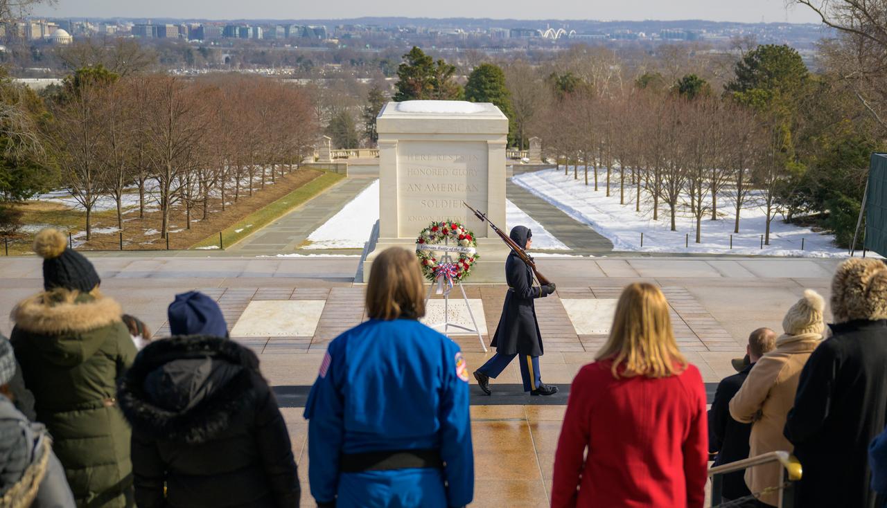NASA Astronaut Kayla Barron, left in blue, and NASA acting Administrator Janet Petro, in red, watch the changing of the guard at the Tomb of the Unknowns as part of NASA's Day of Remembrance, Thursday, Jan. 23, 2025, at Arlington National Cemetery in Arlington, Va. Wreaths were laid in memory of those men and women who lost their lives in the quest for space exploration. Photo Credit: (NASA/Bill Ingalls)