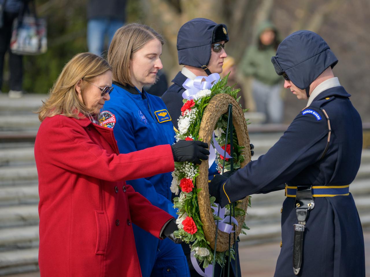 NASA personnel watch as a wreath is laid at the Tomb of the Unknowns by NASA acting Administrator Janet Petro, left, and NASA Astronaut Kayla Barron, as part of NASA's Day of Remembrance, Thursday, Jan. 23, 2025, at Arlington National Cemetery in Arlington, Va. The wreaths were laid in memory of those men and women who lost their lives in the quest for space exploration. Photo Credit: (NASA/Bill Ingalls)