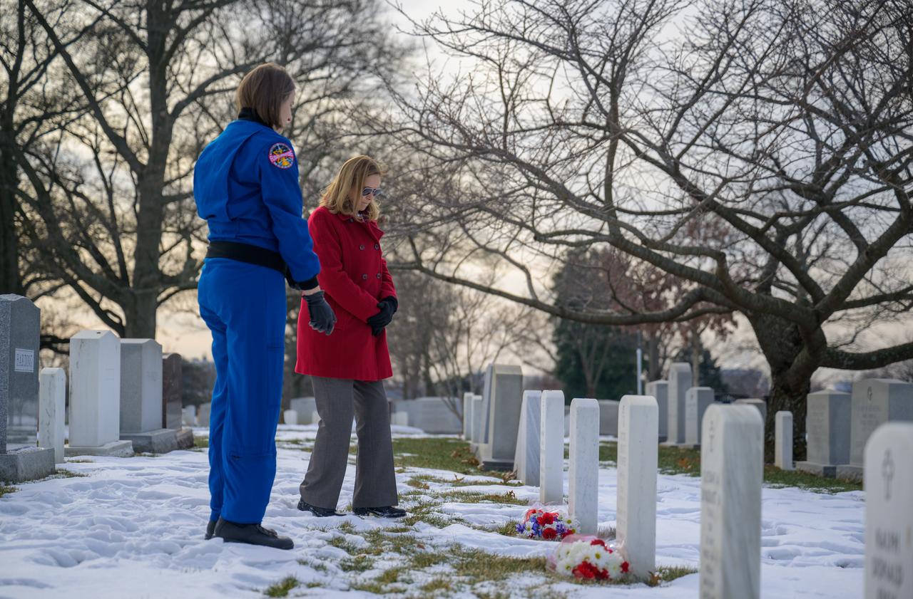 NASA acting Administrator Janet Petro, background, and NASA Astronaut Kayla Barron, place flowers at the Apollo 1 grave sites of Virgil I. “Gus” Grissom, and Roger B. Chaffee as part of NASA's Day of Remembrance, Thursday, Jan. 23, 2025, at Arlington National Cemetery in Arlington, Va. Photo Credit: (NASA/Bill Ingalls)