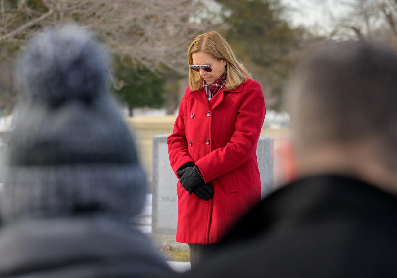 NASA acting Administrator Janet Petro leads guests to a moment of silence at the Apollo 1 monument as part of NASA's Day of Remembrance, Thursday, Jan. 23, 2025, at Arlington National Cemetery in Arlington, Va. The monument honors and memorializes the Apollo 1 crew of Virgil I. “Gus” Grissom, Edward H. White II, and Roger B. Chaffee. Photo Credit: (NASA/Bill Ingalls)