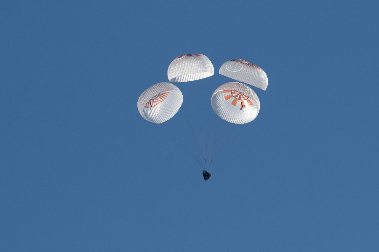 A SpaceX Dragon spacecraft is seen as it lands with NASA astronauts Nick Hague, Suni Williams, Butch Wilmore, and Roscosmos cosmonaut Aleksandr Gorbunov aboard in the water off the coast of Tallahassee, Florida, Tuesday, March 18, 2025. Hague, Gorbunov, Williams, and Wilmore are returning from a long-duration science expedition aboard the International Space Station. Photo Credit: (NASA/Keegan Barber)