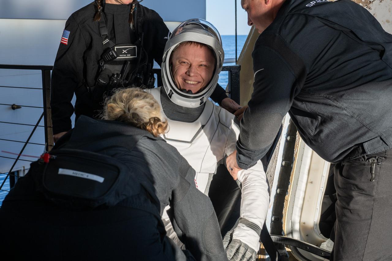 Roscosmos cosmonaut Aleksandr Gorbunov is helped out of a SpaceX Dragon spacecraft onboard the SpaceX recovery ship MEGAN after he, NASA astronauts Nick Hague, Suni Williams, and Butch Wilmore, landed in the water off the coast of Tallahassee, Florida, Tuesday, March 18, 2025. Hague, Gorbunov, Williams, and Wilmore are returning from a long-duration science expedition aboard the International Space Station. Photo Credit: (NASA/Keegan Barber)