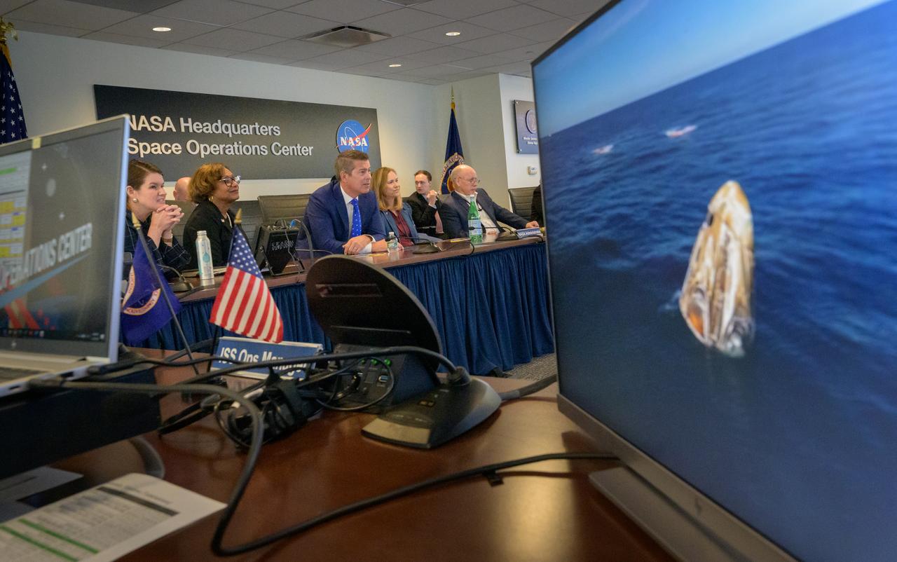 NASA Deputy Associate Administrator Casey Swails, left, acting NASA Associate Administrator Vanessa Wyche, U.S. Transportation Secretary Sean Duffy, acting NASA Administrator Janet Petro, NASA Associate Administrator for the Space Operations Mission Directorate Ken Bowersox, right, watch the SpaceX Dragon spacecraft splash down with NASA astronauts Butch Wilmore, Suni Williams, Nick Hague, and Roscosmos cosmonaut Aleksandr Gorbunov, Tuesday, March 18, 2025, from the Space Operations Center at the Mary W. Jackson NASA Headquarters Building in Washington. Photo Credit: (NASA/Bill Ingalls)
