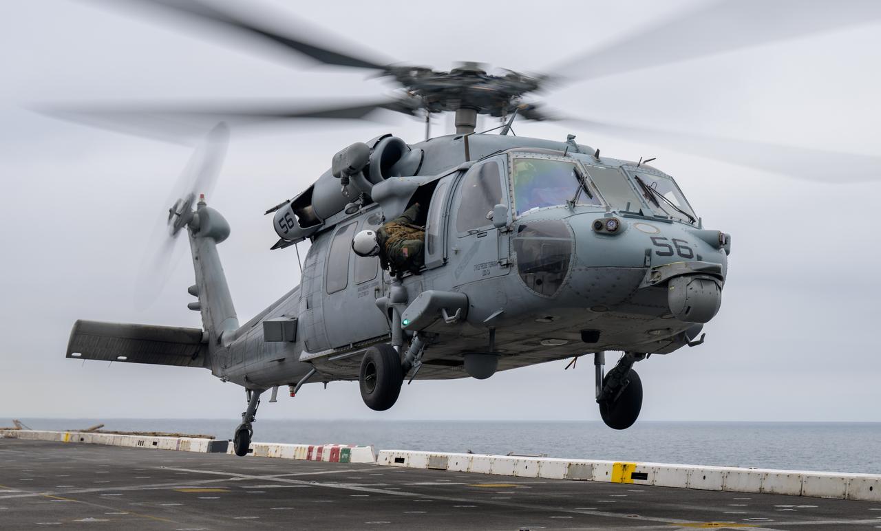 A helicopter lands on USS Somerset off the coast of California, as NASA and Department of Defense teams participate in Underway Recovery Test-12, Tuesday, March 25, 2025. During the test, teams are practicing to ensure recovery procedures are validated as NASA plans to send the Artemis II astronauts around the Moon and splashdown in the Pacific Ocean.  Photo Credit: (NASA/Bill Ingalls)