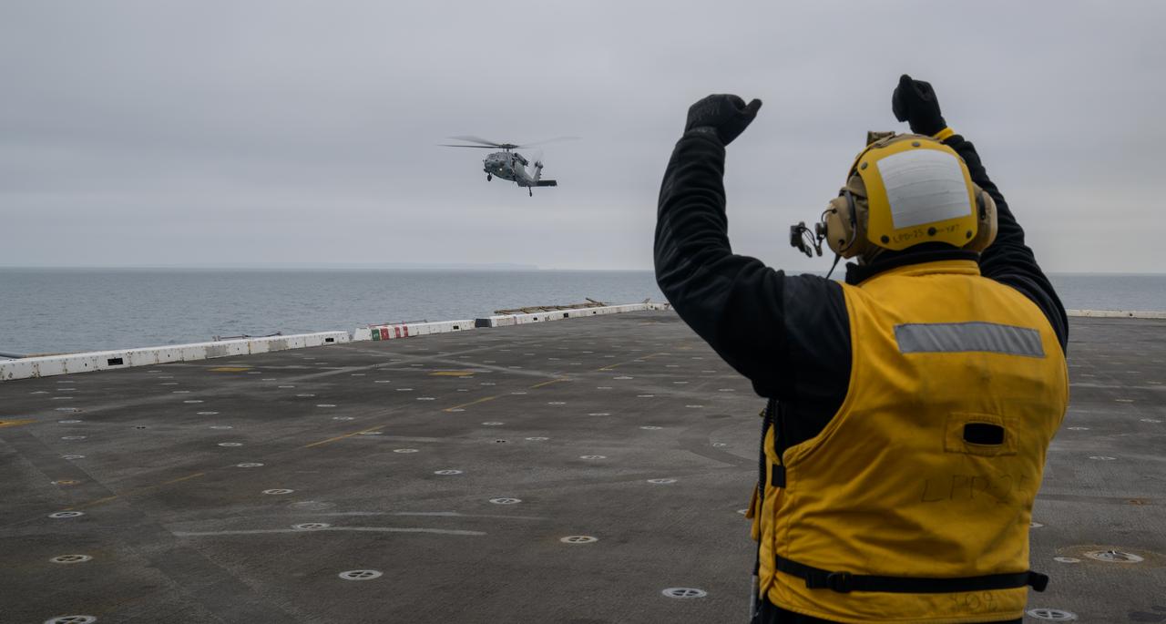 A helicopter lands on USS Somerset off the coast of California, as NASA and Department of Defense teams participate in Underway Recovery Test-12, Tuesday, March 25, 2025. During the test, teams are practicing to ensure recovery procedures are validated as NASA plans to send the Artemis II astronauts around the Moon and splashdown in the Pacific Ocean.  Photo Credit: (NASA/Bill Ingalls)