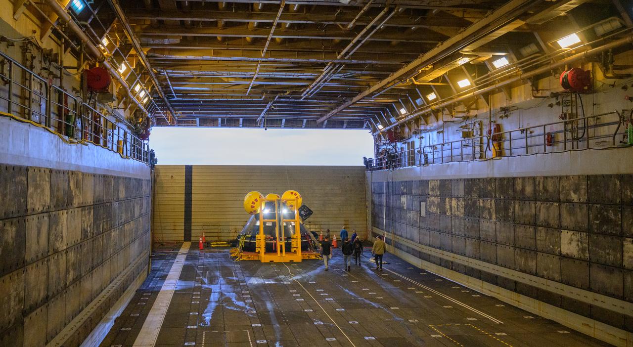 The Crew Module Test Article (CMTA), a full scale mockup of the Orion spacecraft, sits nestled in its cradle during Underway Recovery Test-12 onboard USS Somerset off the coast of California, Wednesday, March 26, 2025. During the test, NASA and Department of Defense teams are practicing to ensure recovery procedures are validated as NASA plans to send Artemis II astronauts around the Moon and splashdown in the Pacific Ocean. Photo Credit: (NASA/Joel Kowsky)
