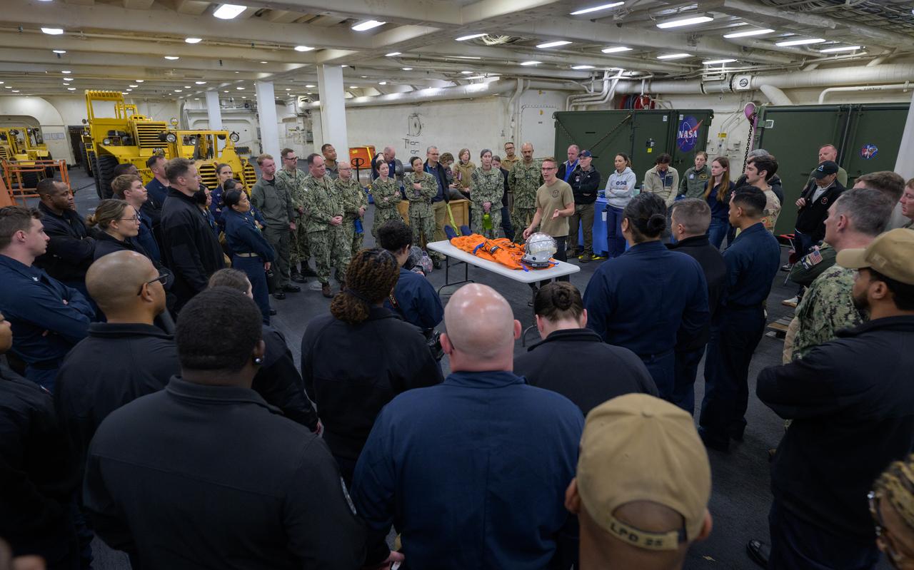 NASA and Department of Defense teams familiarize themselves with the pressure suits the Artemis II crew will be wearing when they return from their mission during Underway Recovery Test-12 onboard USS Somerset off the coast of California, Wednesday, March 26, 2025. During the test, NASA and Department of Defense teams are practicing to ensure recovery procedures are validated as NASA plans to send Artemis II astronauts around the Moon and splashdown in the Pacific Ocean. Photo Credit: (NASA/Joel Kowsky)