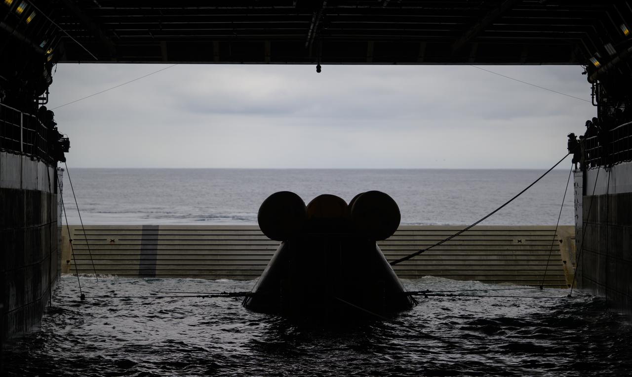 The Crew Module Test Article (CMTA), a full scale mockup of the Orion spacecraft, sits nestled in its cradle during Underway Recovery Test-12 onboard USS Somerset off the coast of California, Wednesday, March 26, 2025. During the test, NASA and Department of Defense teams are practicing to ensure recovery procedures are validated as NASA plans to send Artemis II astronauts around the Moon and splashdown in the Pacific Ocean. Photo Credit: (NASA/Joel Kowsky)