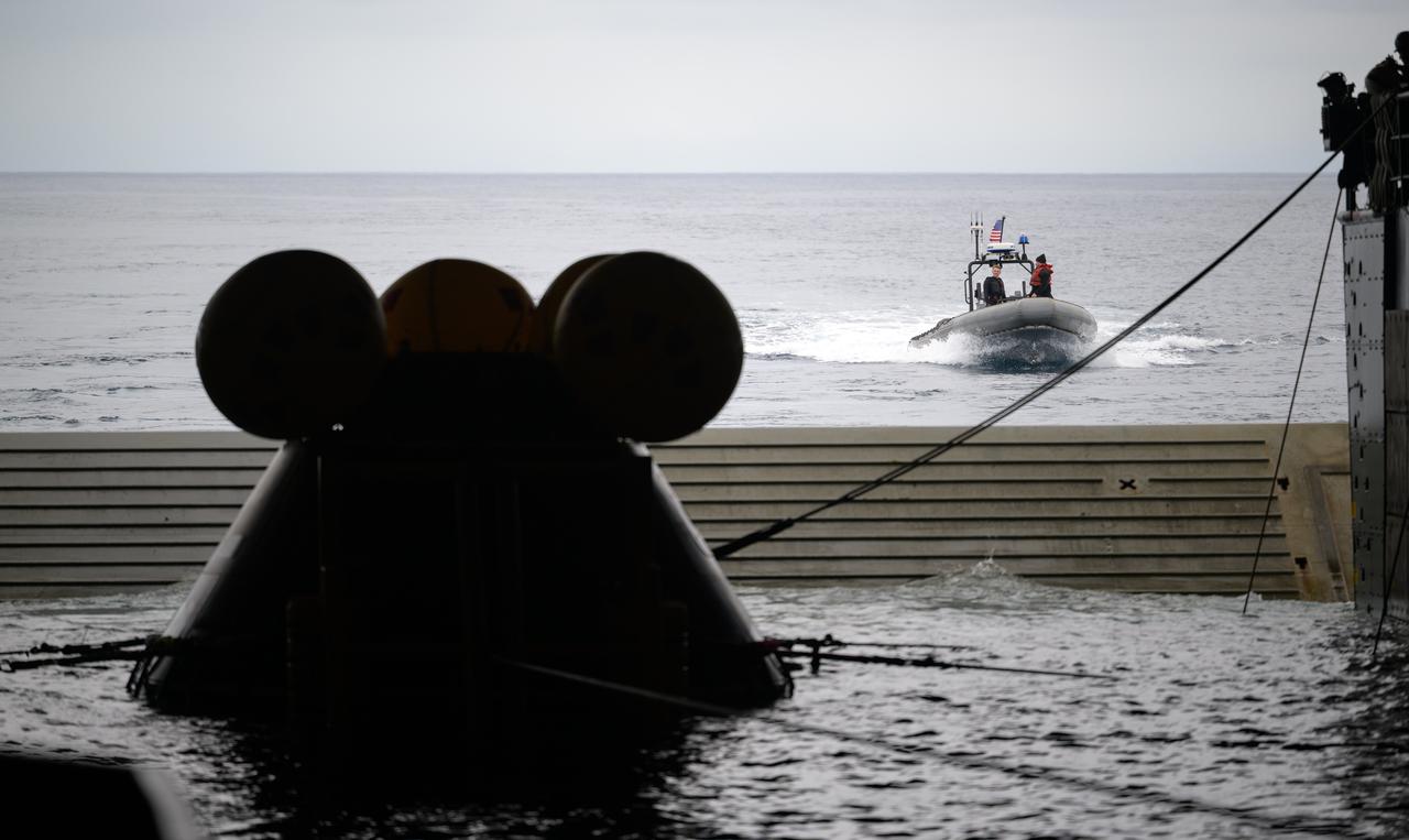 The Crew Module Test Article (CMTA), a full scale mockup of the Orion spacecraft, sits nestled in its cradle during Underway Recovery Test-12 onboard USS Somerset off the coast of California, Wednesday, March 26, 2025. During the test, NASA and Department of Defense teams are practicing to ensure recovery procedures are validated as NASA plans to send Artemis II astronauts around the Moon and splashdown in the Pacific Ocean. Photo Credit: (NASA/Joel Kowsky)