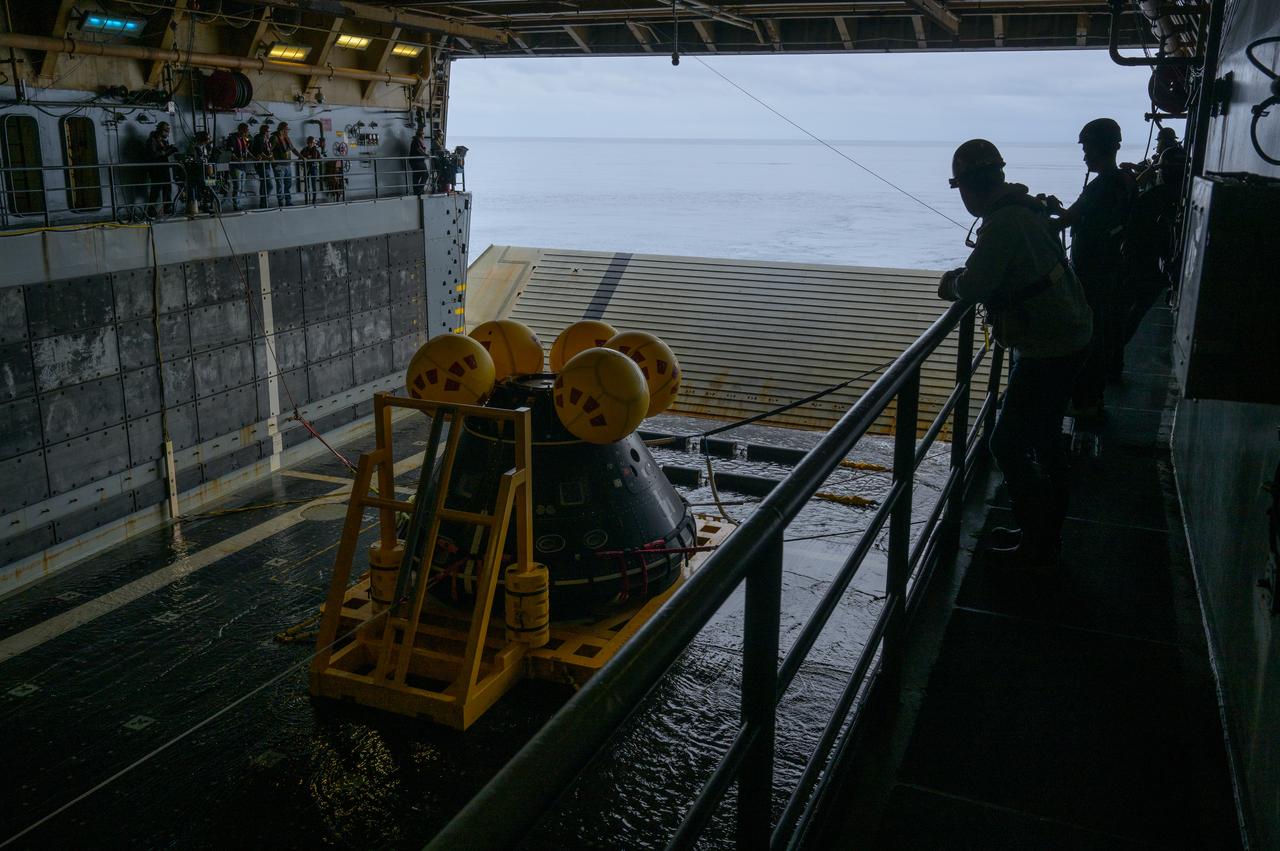The Crew Module Test Article (CMTA), a full scale mockup of the Orion spacecraft, sits nestled in its cradle during Underway Recovery Test-12 onboard USS Somerset off the coast of California, Wednesday, March 26, 2025. During the test, NASA and Department of Defense teams are practicing to ensure recovery procedures are validated as NASA plans to send Artemis II astronauts around the Moon and splashdown in the Pacific Ocean. Photo Credit: (NASA/Bill Ingalls)