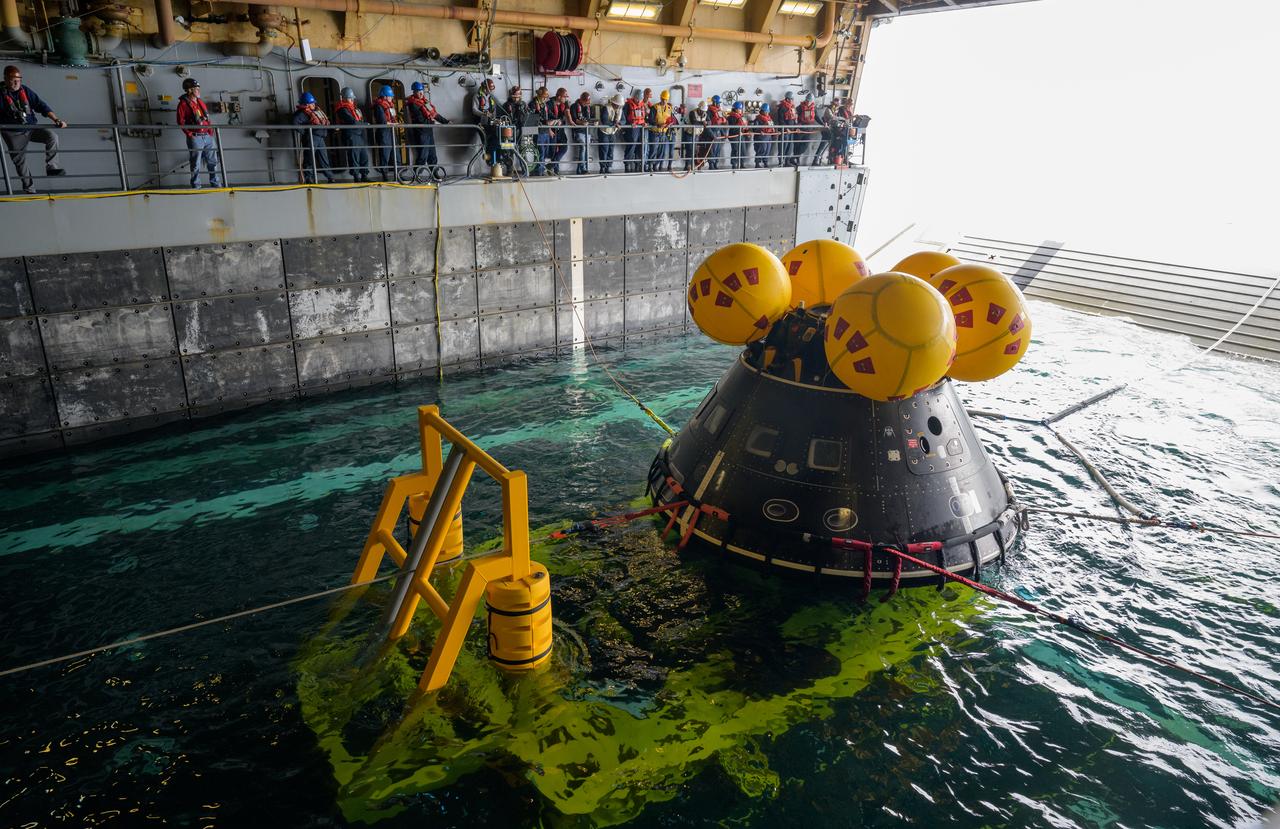 Mission support teams are seen off the stern of USS Somerset as they practice with the Crew Module Test Article (CMTA), a full scale mockup of the Orion spacecraft, during Underway Recovery Test-12 off the coast of California, Wednesday, March 26, 2025. During the test, NASA and Department of Defense teams are practicing to ensure recovery procedures are validated as NASA plans to send Artemis II astronauts around the Moon and splashdown in the Pacific Ocean. Photo Credit: (NASA/Bill Ingalls)