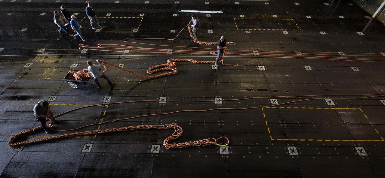 Teams clean up after completing the days activities during Underway Recovery Test-12 onboard USS Somerset, Wednesday, March 26, 2025. During the test, NASA and Department of Defense teams are practicing to ensure recovery procedures are validated as NASA plans to send the Artemis II astronauts around the Moon and splashdown in the Pacific Ocean.  Photo Credit: (NASA/Joel Kowsky)