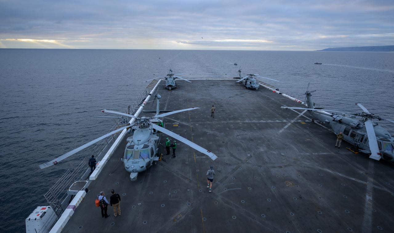 Navy MH-60 Seahawk helicopters are seen onboard USS Somerset off the coast of California, as NASA and Department of Defense teams participate in Underway Recovery Test-12, Thursday, March 27, 2025. During the test, teams are practicing to ensure recovery procedures are validated as NASA plans to send the Artemis II astronauts around the Moon and splashdown in the Pacific Ocean.  Photo Credit: (NASA/Bill Ingalls)