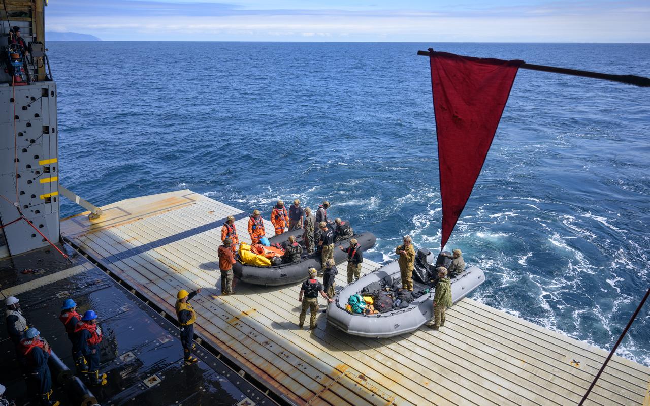 NASA astronauts Deniz Burnham, Andre Douglas, and ESA (European Space Agency) astronaut Luca Parmitano, get in boats that will take them to the Crew Module Test Article (CMTA) during Underway Recovery Test-12 onboard USS Somerset off the coast of California, Thursday, March 27, 2025. During the test, NASA and Department of Defense teams are practicing to ensure recovery procedures are validated as NASA plans to send Artemis II astronauts around the Moon and splashdown in the Pacific Ocean.  Photo Credit: (NASA/Bill Ingalls)