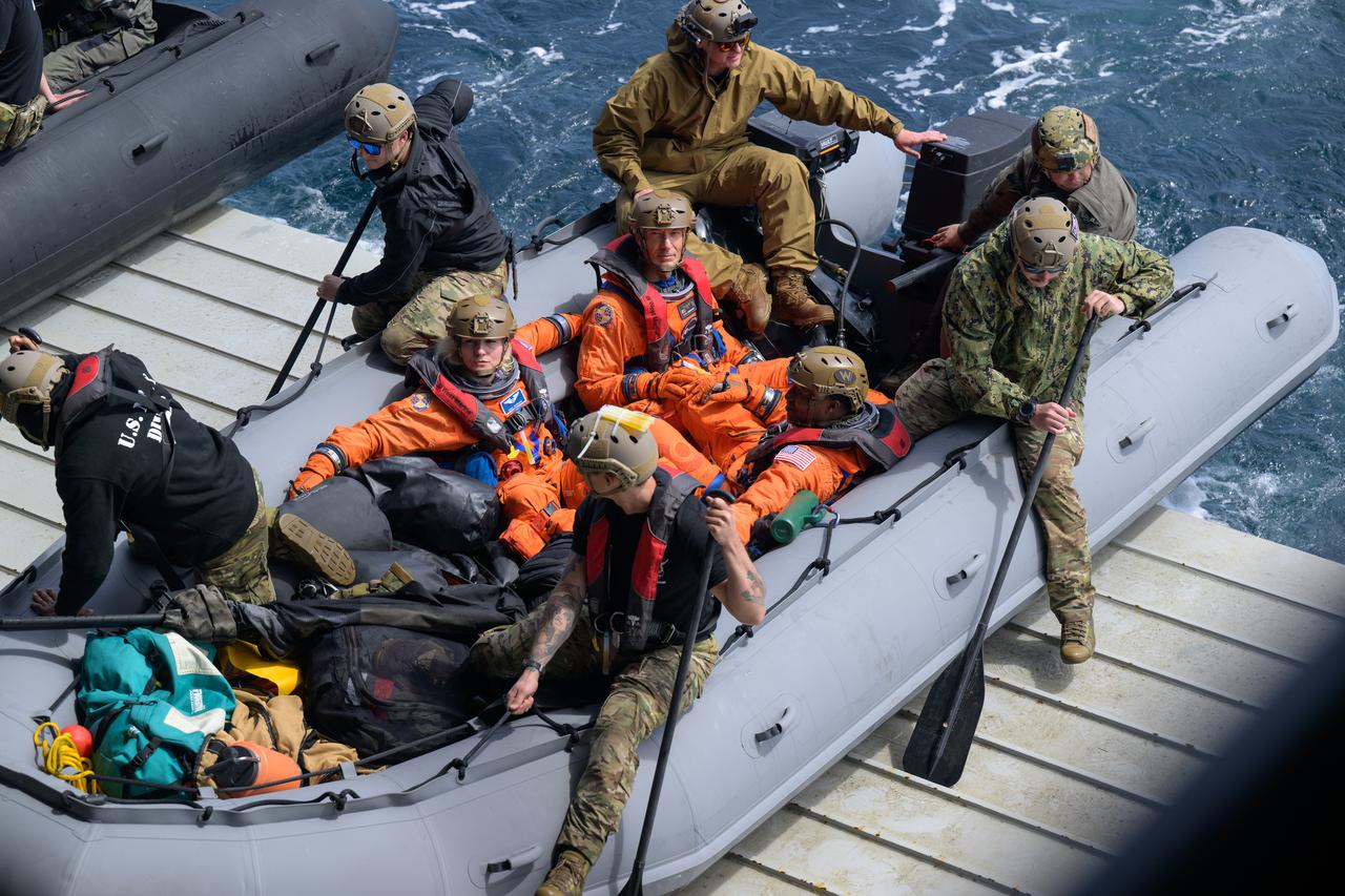 NASA astronauts Deniz Burnham, Andre Douglas, and ESA (European Space Agency) astronaut Luca Parmitano, get in boats that will take them to the Crew Module Test Article (CMTA) during Underway Recovery Test-12 onboard USS Somerset off the coast of California, Thursday, March 27, 2025. During the test, NASA and Department of Defense teams are practicing to ensure recovery procedures are validated as NASA plans to send Artemis II astronauts around the Moon and splashdown in the Pacific Ocean.  Photo Credit: (NASA/Bill Ingalls)
