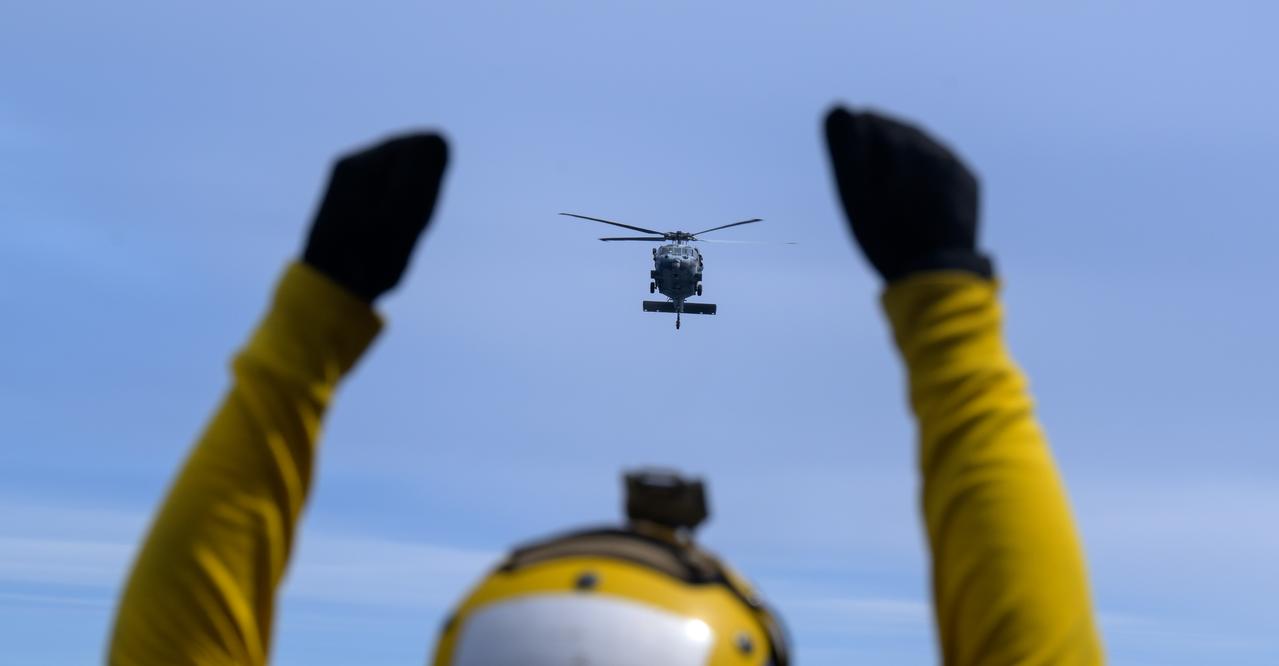 USS Somerset sailors direct the landing of helicopters with astronauts during Underway Recovery Test-12 onboard USS Somerset off the coast of California, Thursday, March 27, 2025. During the test, NASA and Department of Defense teams are practicing to ensure recovery procedures are validated as NASA plans to send Artemis II astronauts around the Moon and splashdown in the Pacific Ocean.  Photo Credit: (NASA/Bill Ingalls)